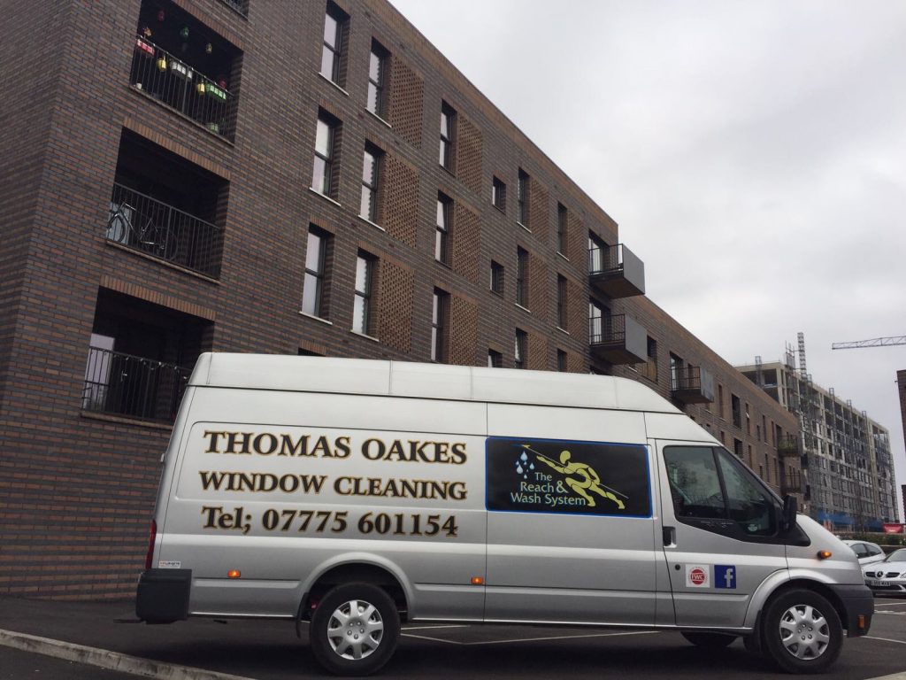 thomas oakes window cleaning van infront of building